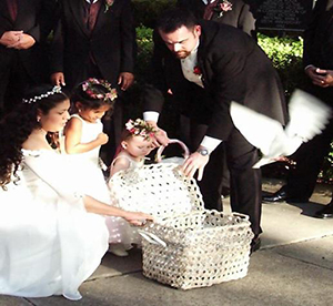 groom, bride and flower girls releasing doves from a basket